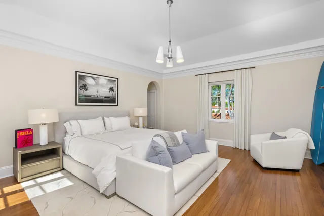 a spacious bathroom with a tub sink and mirror