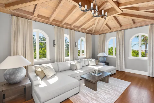 a living room with patio furniture and a swimming pool