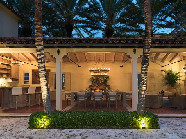 a view of a house with backyard and sitting area
