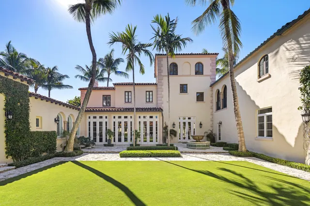 a view of a house with swimming pool and a chairs
