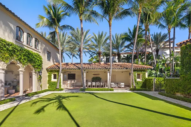 a view of a fountain with big trees