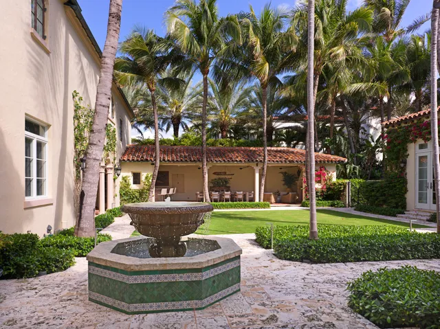 a view of a house with swimming pool and a yard