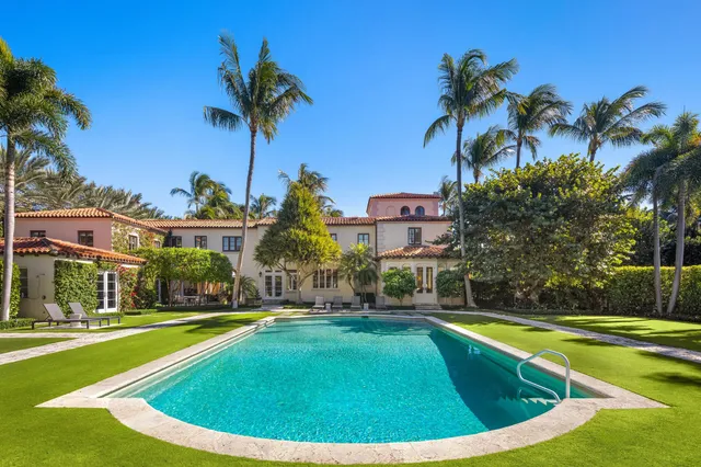 a view of a swimming pool with a table and chairs