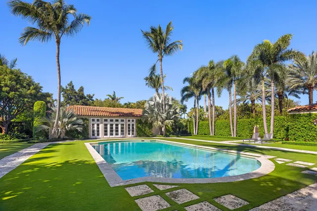 a view of a house with swimming pool and sitting area