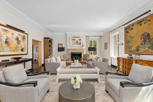 a view of a dining room with furniture large windows and wooden floor
