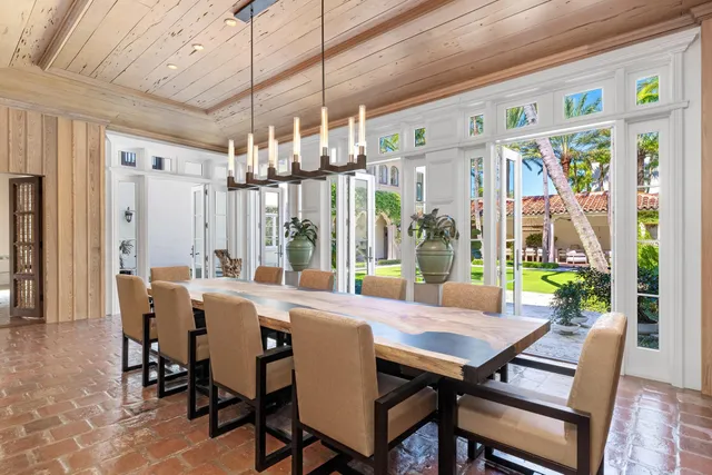 a living room with furniture and floor to ceiling windows
