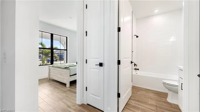 a bedroom with a bed and a night stand