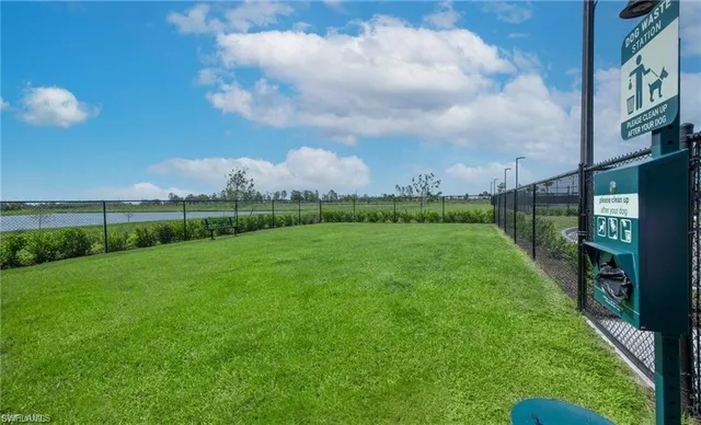 a living room with lots of furniture and kitchen view