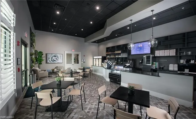 a dining area with furniture and a large window