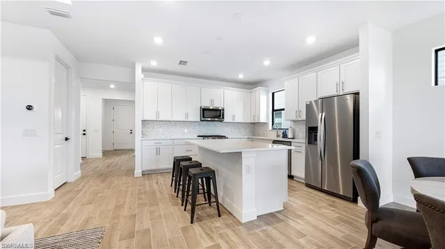 a large white kitchen with a large window