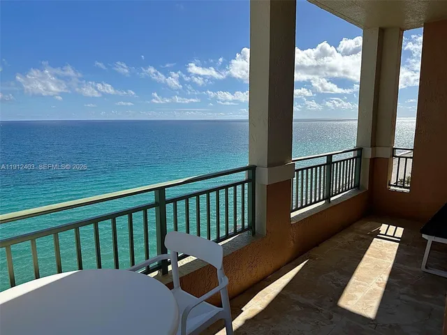 a view of a balcony with wooden floor