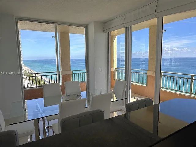 a view of two room with furniture and a window