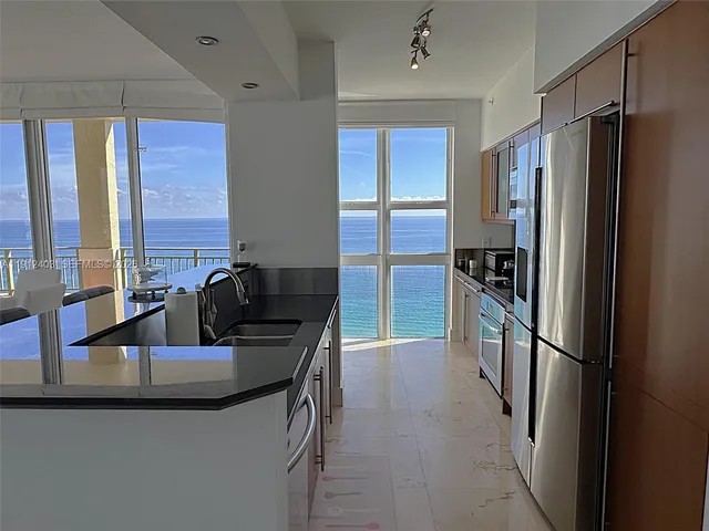 a view of a livingroom with furniture and a flat screen tv
