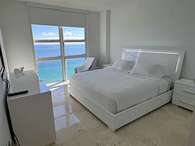 a bedroom with a large bed and a closet