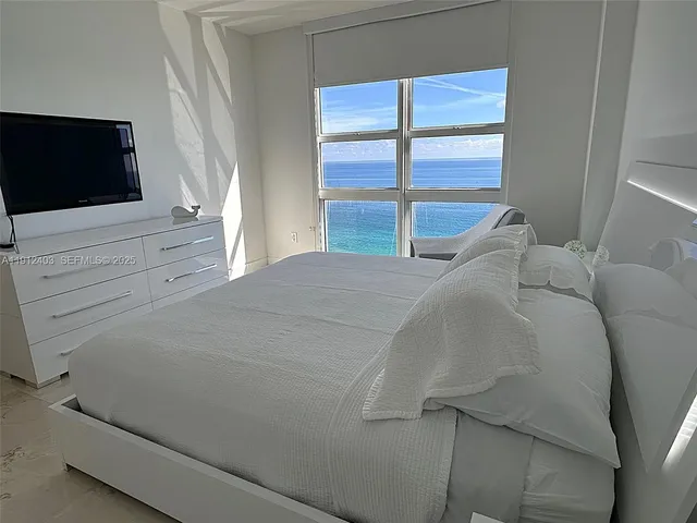 a bedroom with two beds and a window