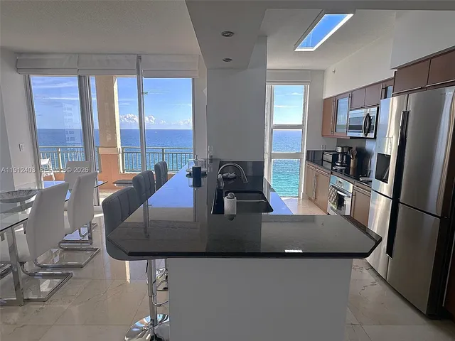 a view of a swimming pool with a bench and palm trees