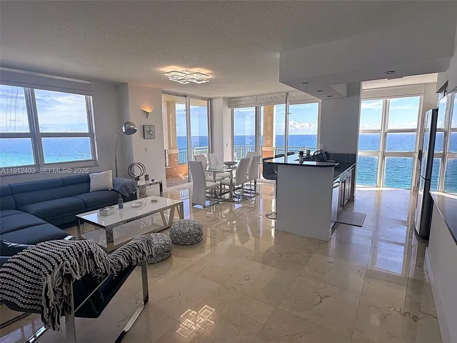 a view of a balcony with furniture and chandelier