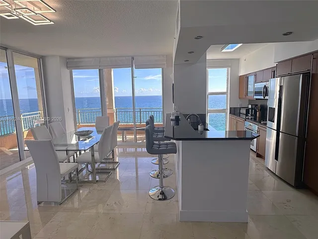 a living room with large couches and flat screen tv