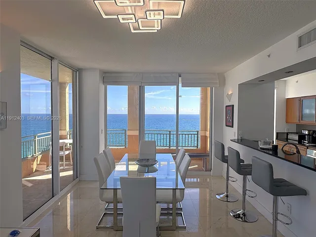 a kitchen with a refrigerator sink and cabinets
