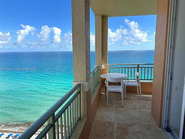 a bedroom with a bed a flat screen tv and a large window
