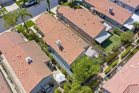 an aerial view of residential houses with outdoor space