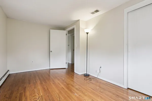 an empty room with wooden floor