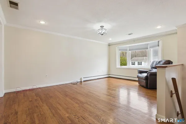 a view of a livingroom with furniture and hardwood floor