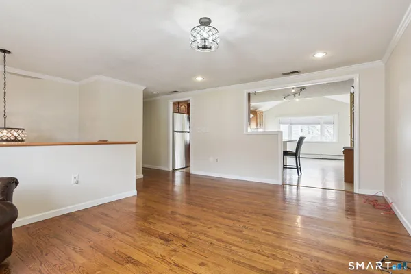 a view of a kitchen with wooden floor and a ceiling fan