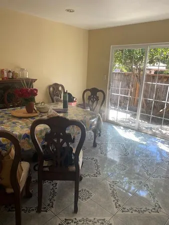 a view of a dining room with furniture and a floor to ceiling window