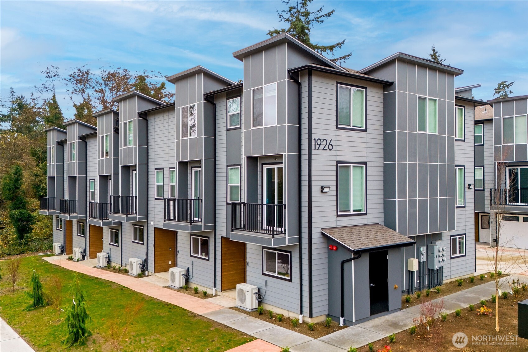 a front view of a building with a garden