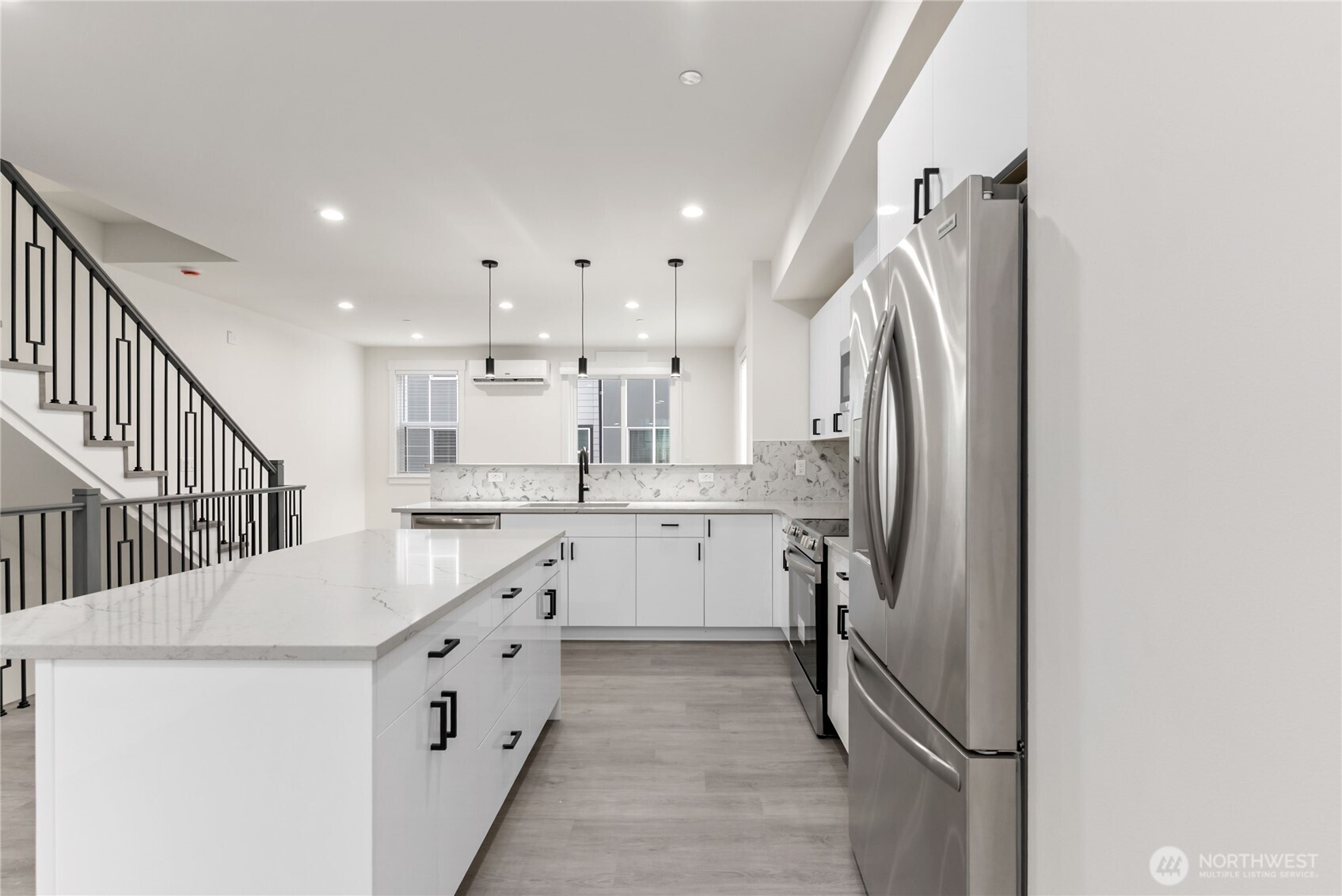 1926 South Washington Street, Unit B206 Tacoma, WA 98405 - Photo 11 of 39 a kitchen with white cabinets and refrigerator