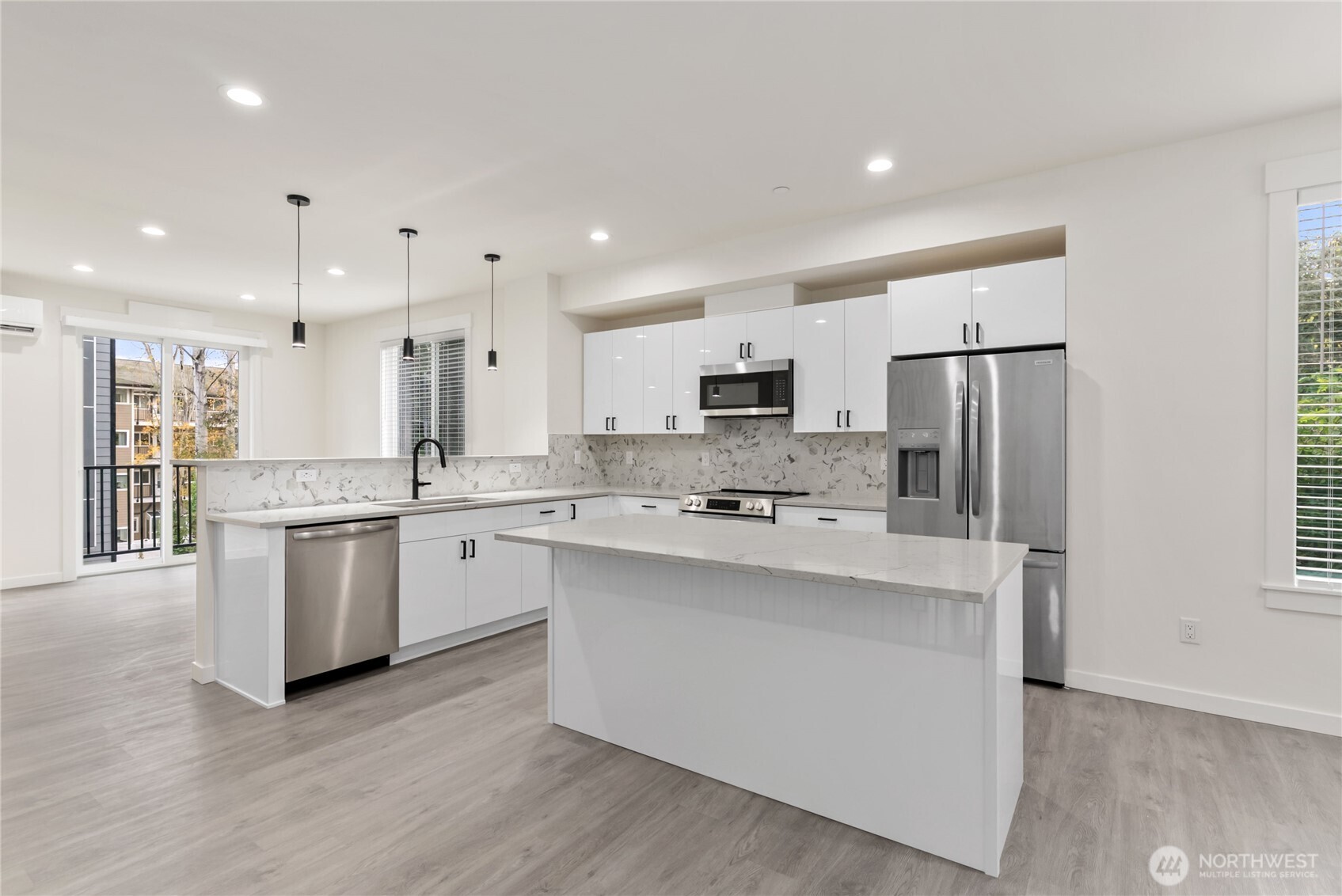 1926 South Washington Street, Unit B206 Tacoma, WA 98405 - Photo 13 of 39 a kitchen with stainless steel appliances a refrigerator sink and microwave