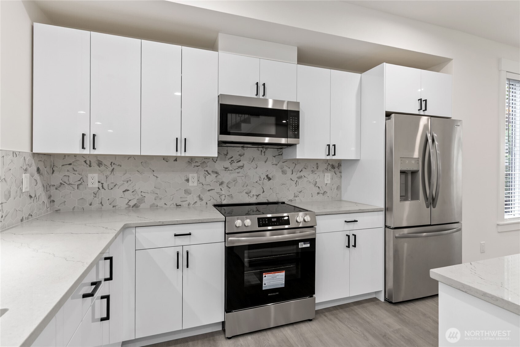 1926 South Washington Street, Unit B206 Tacoma, WA 98405 - Photo 14 of 39 a kitchen with cabinets stainless steel appliances and wooden floor