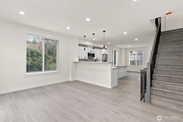 a view of kitchen with kitchen island wooden floor wooden floor and appliances