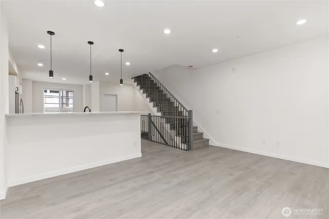 a view of kitchen and hall with wooden floor