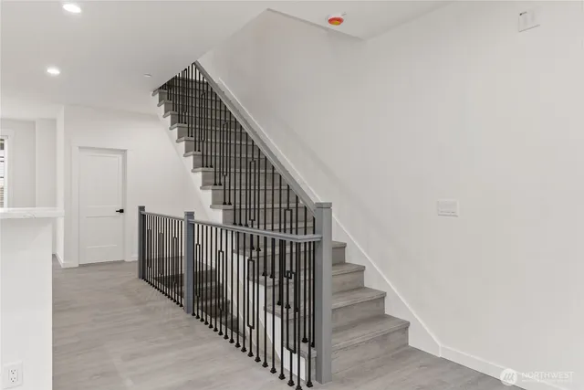 a view of entryway and hall with wooden floor