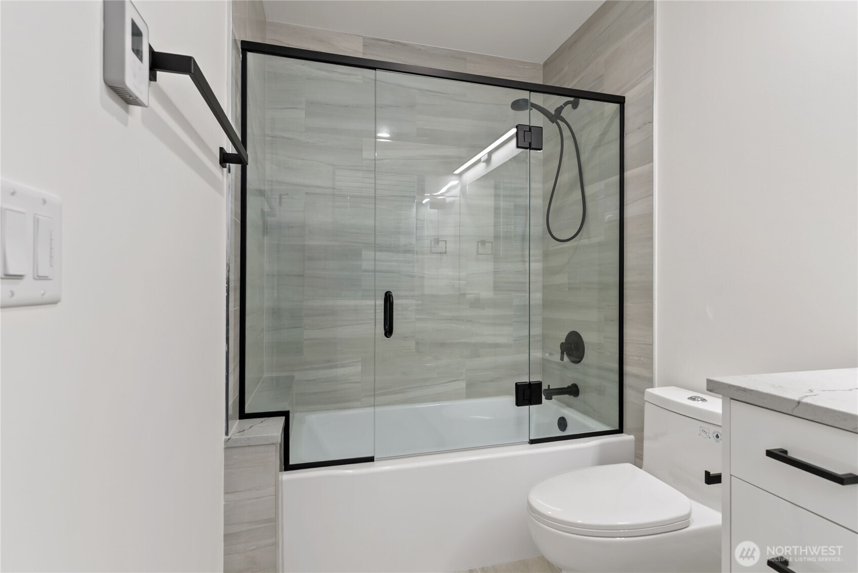 1926 South Washington Street, Unit B206 Tacoma, WA 98405 - Photo 27 of 39 a bathroom with a toilet and a shower