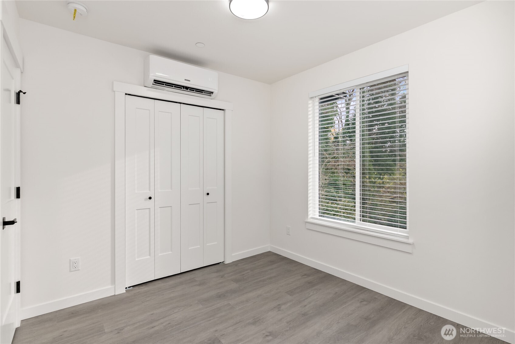 1926 South Washington Street, Unit B206 Tacoma, WA 98405 - Photo 29 of 39 a view of an empty room with wooden floor and a window
