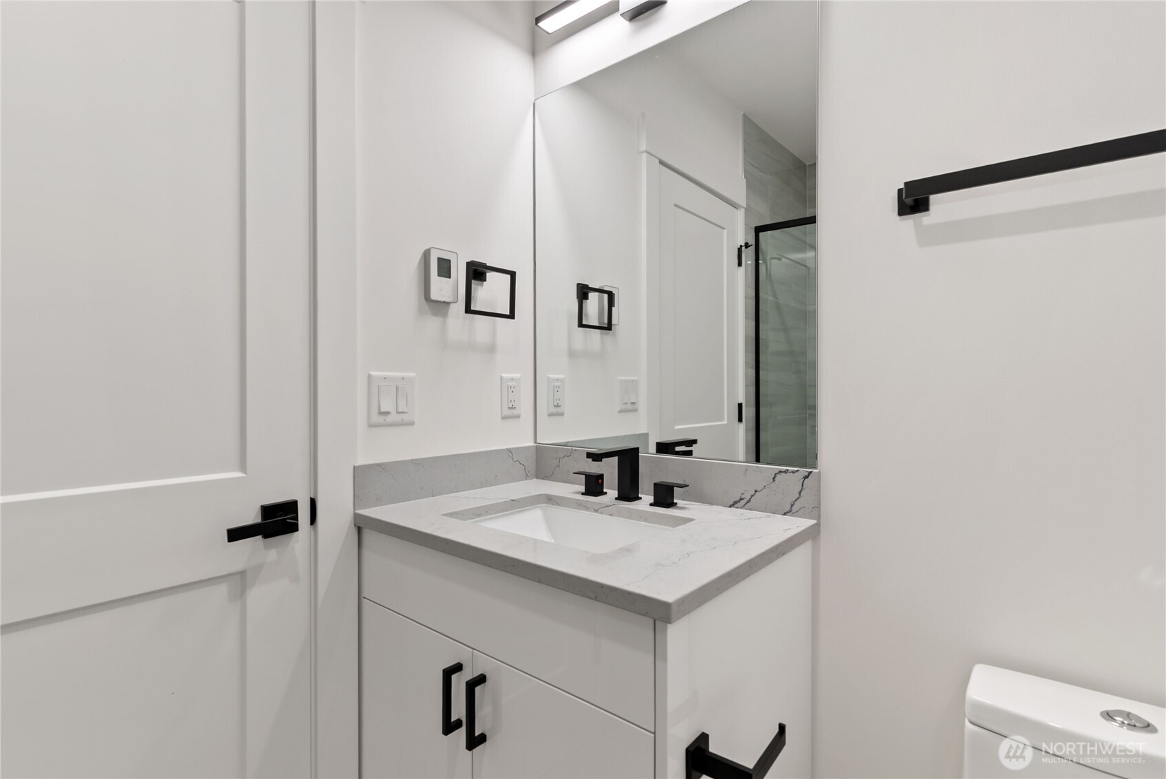 1926 South Washington Street, Unit B206 Tacoma, WA 98405 - Photo 32 of 39 a bathroom with a sink and a mirror