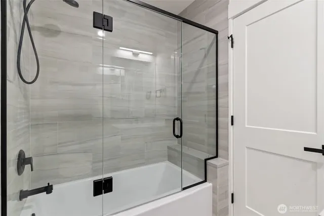 a bathroom with a shower and a bathtub