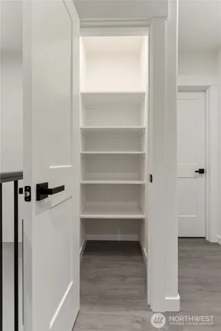 a view of walk in closet with empty racks