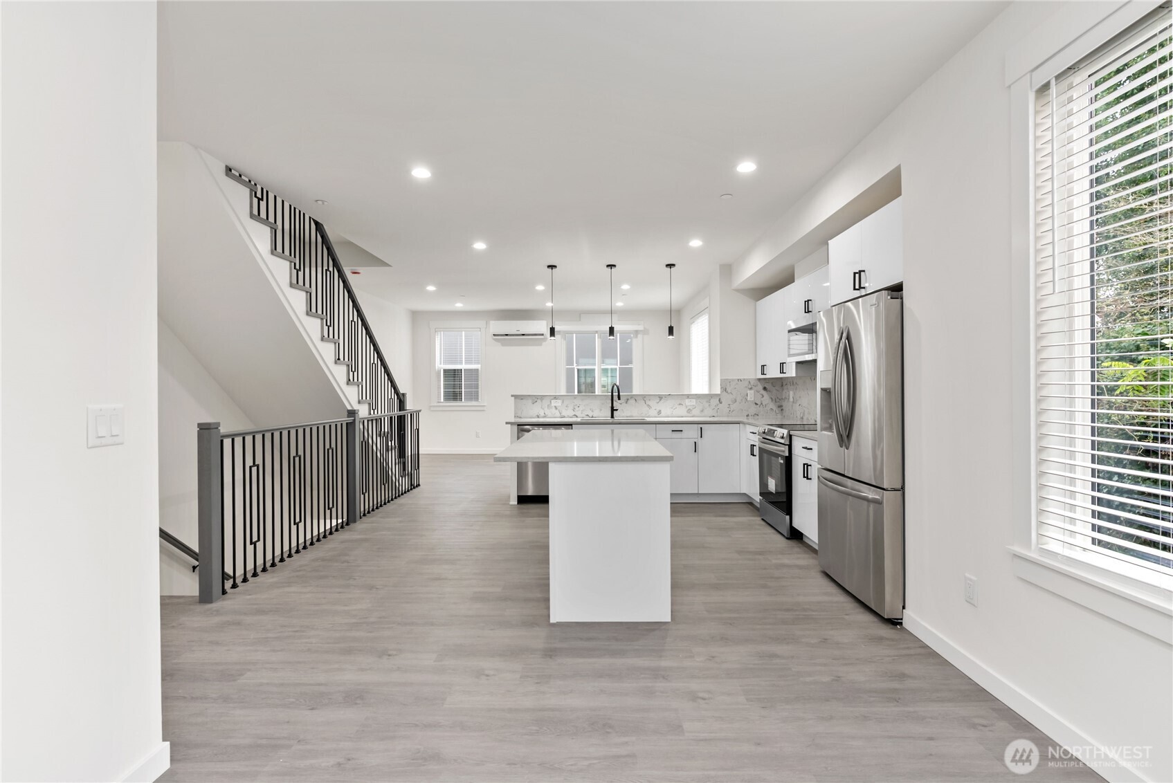 1926 South Washington Street, Unit B206 Tacoma, WA 98405 - Photo 8 of 39 a kitchen with stainless steel appliances kitchen island a stove a refrigerator a sink and a microwave