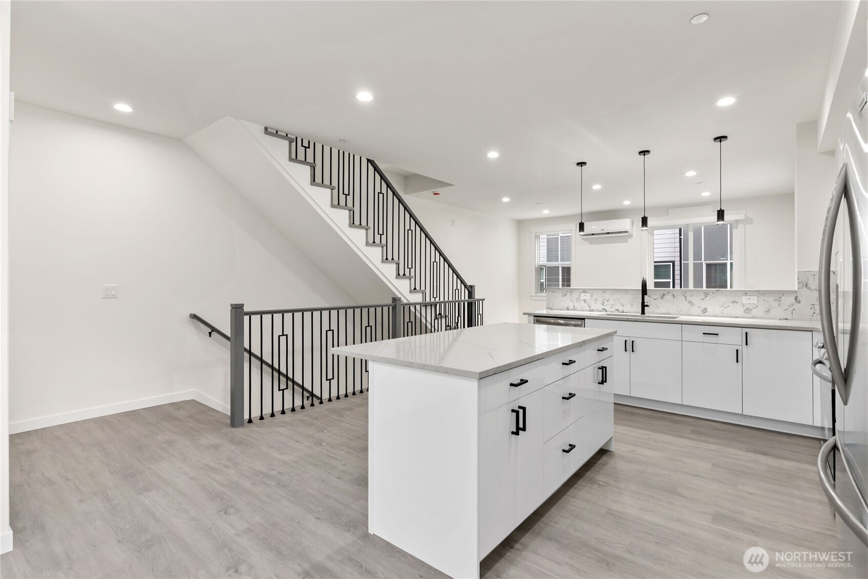 1926 South Washington Street, Unit B206 Tacoma, WA 98405 - Photo 10 of 39 a kitchen with cabinets a sink and wooden floors