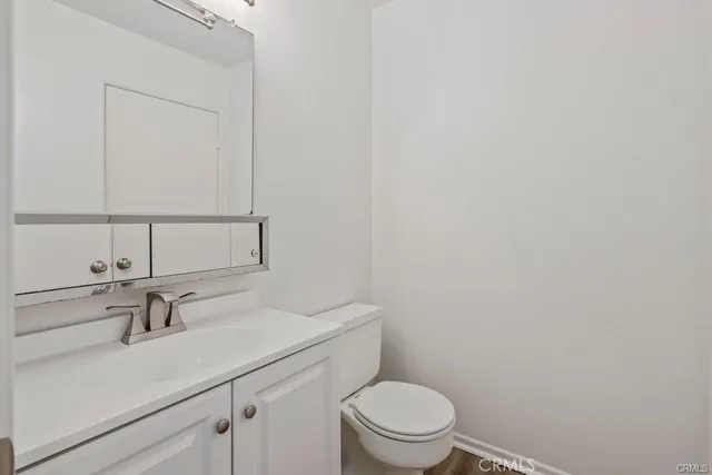 a bathroom with a sink a toilet and mirror