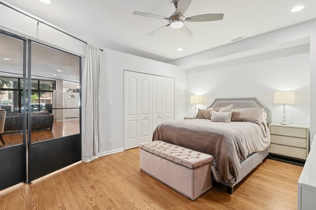 2518 North Willetts Court, Unit GS Chicago, IL 60647 - Photo 29 of 34 a bedroom with a large bed and a chandelier