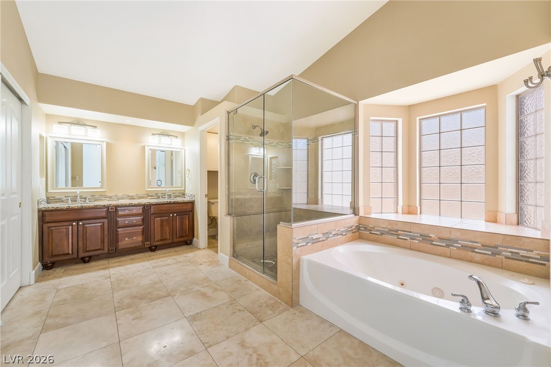 271 Pointe Ranier Avenue Henderson, NV 89012 - Photo 20 of 26 Luxurious bathing retreat featuring a spacious tub and separate glass shower.