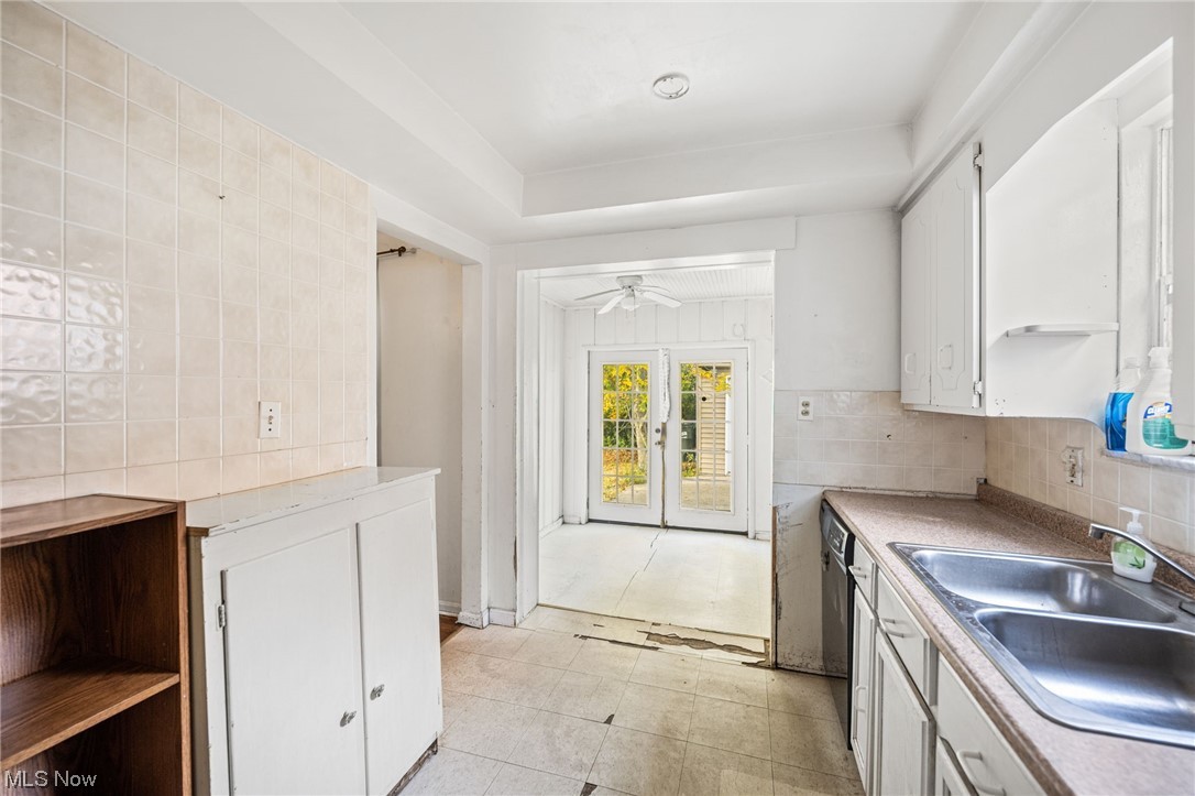 3799 Colony Road South Euclid, OH 44118 - Photo 11 of 34 Kitchen featuring french doors, sink, light tile floors, ceiling fan, and white cabinets