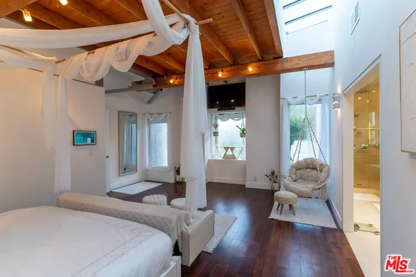 a bedroom with wooden floor