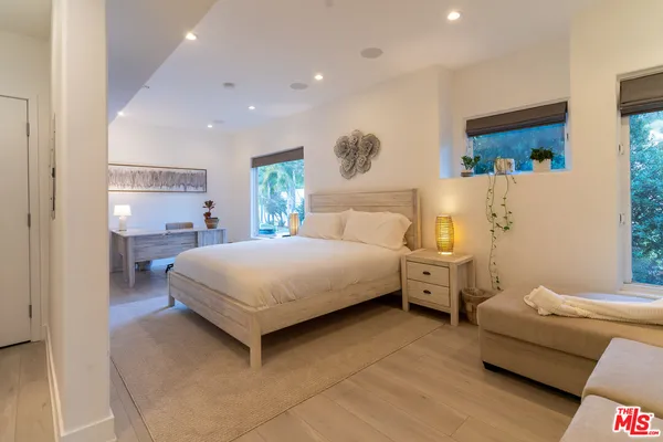 a bedroom with a bed and a couch