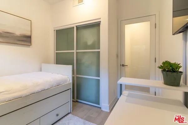 a room with a bed and a potted plant